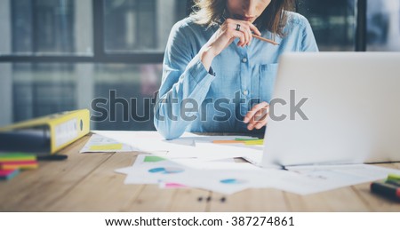 Young architect work project. Photo woman working with new startup project in modern loft. Generic design notebook on wood table. Horizontal, film effect