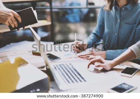 Teamwork. Photo young businessmans crew working with new startup project. Generic design notebook on wood table.  Analyze plans, pencil hands, keyboard. Blurred background, film effect