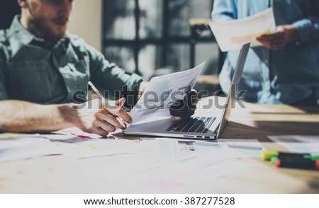 Photo bearded businessman working with new project. Generic design notebook on wood table.  Analyze plans hands, keyboard. Blurred background, film effect
