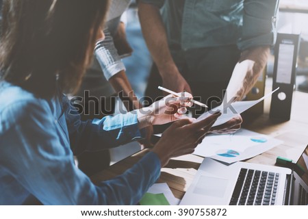 Team job succes. Photo young business managers  working with new startup project in office. Analyze document, plans. Generic design notebook on wood table, papers, documents. Horizontal, blurred
