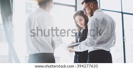 Business team work process. Photo young professionals crew working with new startup project. Project managers meeting. Analyze business plans laptop. Blurred background, film effect. Wide mockup