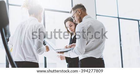 Business team work process. Photo professional crew working with new startup project. Project managers meeting. Analyze business plans laptop. Blurred background, film effect. Wide
