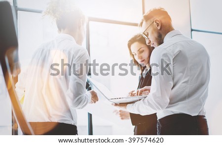Business team work process. Photo professional crew working with new startup project. Project managers meeting. Analyze business plans laptop. Blurred background, film effect, bokeh. Horizontal
