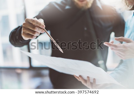 Team job succes.Closeup photo young business managers  working with new startup project in modern office.Analyze document, plans. Holding papers, documents, pencil hands. Horizontal, blurred