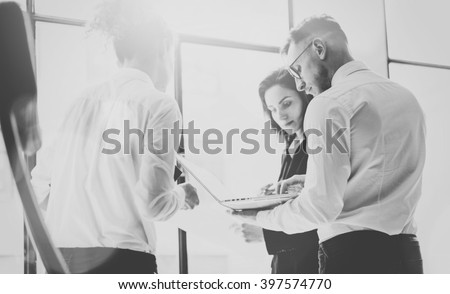 Business team work process. Photo professional crew working with new startup project. Project managers meeting. Analyze business plans laptop. Blurred background, film effect, black white. Horizontal