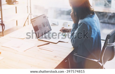 Account manager working.Photo young businesswoman work with new startup project in office.Talking mobile phone, write message. Laptop wood table,cup coffee,documents.Horizontal,blurred.Film effect
