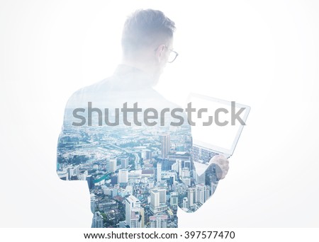Double exposure young bearded businessman wearing black shirt holding contemporary notebook hands.Isolated white,modern city background.Blank screen ready for your business message.Horizontal mockup