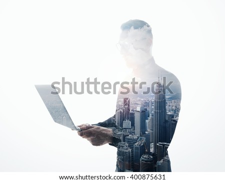 Double exposure bearded businessman wearing black suit and glasses.Banker holding contemporary notebook hands.Work online banking.Isolated white,modern skyscraper city background.Horizontal mockup