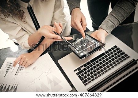 Investment department working process.Photo man showing reports modern tablet screen.Statistics graphics screen.Private banker manager holding pen for signs documents. New business project startup.