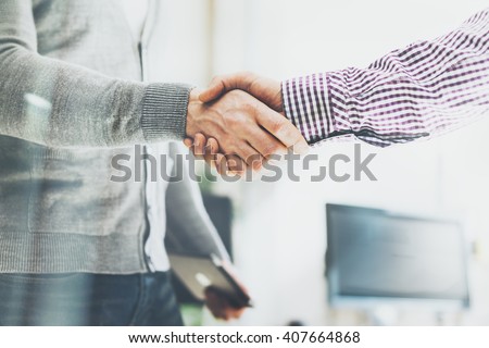 Business partnership meeting. Photo businessmans handshake. Successful businessmen handshaking after good deal. Horizontal, blurred background