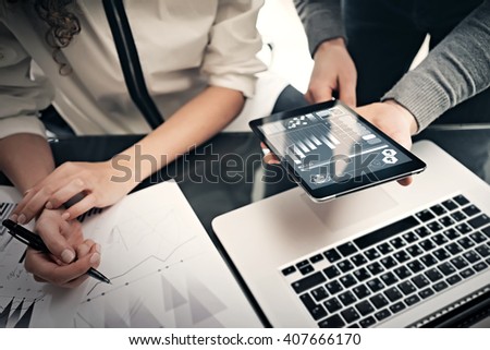 Investment department working process.Photo finance manager showing reports modern tablet screen.Statistics graphics screen.Private banker holding pen for signs documents, business project.Horizontal