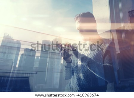 Double exposure photo man touching screen smartphone.Picture bearded trader manager in modern loft.Contemporary city skyscrapers background. Film and bokeh effect.Horizontal