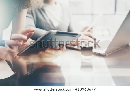 Finance department working process.Picture woman showing business report modern tablet,diagram screen.Banker man holding pen for signs document,discussion startup idea.Horizontal.Film and bokeh effect