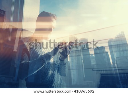 Double exposure photo man touching screen smartphone.Picture bearded trader manager in modern office panoramic view.Contemporary city skyscrapers background. Film and bokeh effect.Horizontal
