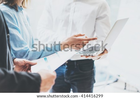 Business team work new ideas process. Photo professional crew working with startup project. Project managers meeting. Analyze business plans laptop. Blurred background, film effect. Horizontal