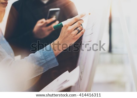 Business meeting office.Closeup photo woman drawing statistic info chart board.Photo account manager crew working with new startup project.Idea presentation,analyze marketing plan.Blurred,film effect.