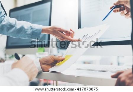 Business meeting office,closeup photo documents holding man hands. Photo account managers crew working with new startup project.Idea presentation,analyze marketing plans.Blurred,film effect,horizontal