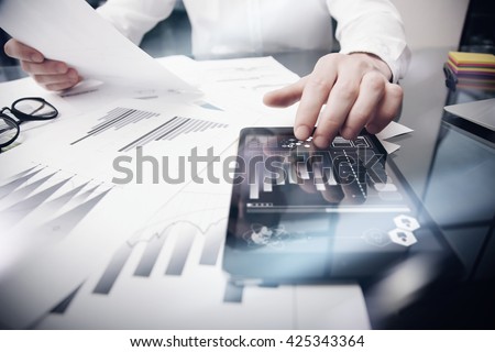 Risk Management Work process.Photo Trader working Market Report Documents Touching Screen Tablet.Using Graphic Icons,Stock Exchanges Reports. Business Project Startup. Horizontal, .
