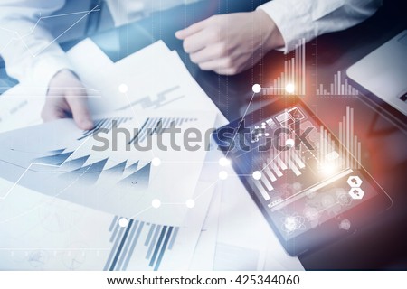 Investment manager working process.Concept photo trader work market report modern tablet.Using electronic device.Graphic icons,stock exchange reports screen interfaces.Business startup.Flares effect.