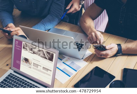 Business Team Brainstorming Process.Coworkers Startup Online Markets.Manager Using Modern Electronic Devices.Creative People Work New Project Wood Table.Notebook,Tablet,Smartphone.Blurred Film Effect