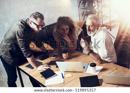 Concept of business people brainstorming.Bearded man talking with account director and creative manager to finding great work solution.Horizontal, blurred background