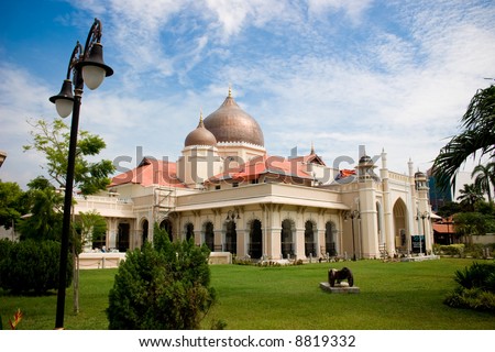 impressive mosque architecture with front garden, blue sky white clouds