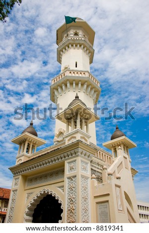 impressive mosque tower architecture with blue sky white clouds