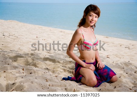 woman kneeling while relaxing on the beach