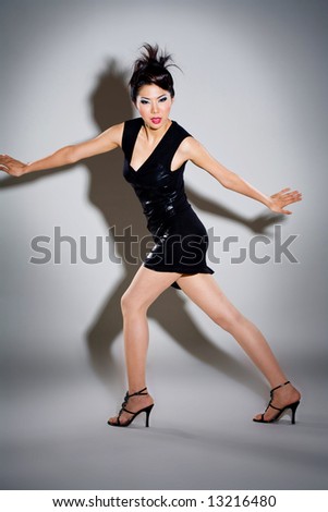asian woman model posing with dramatic lighting in black dress