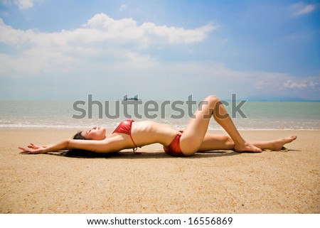 asian woman in bikini lean on the summer beach