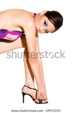 stock photo Beautiful Asian woman model bending over with hands touching 