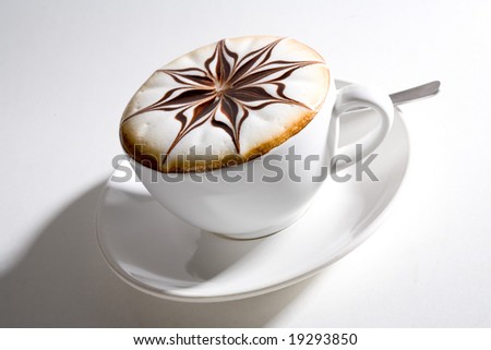 beautifully decorated cup of hot coffee with a star shape chocolate flower