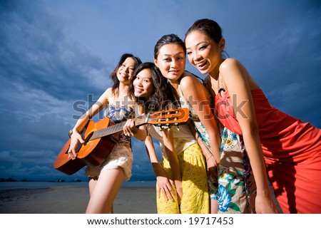http://image.shutterstock.com/display_pic_with_logo/133396/133396,1225383445,1/stock-photo-group-of-asian-girls-having-fun-at-the-beach-playing-guitar-in-the-evening-19717453.jpg