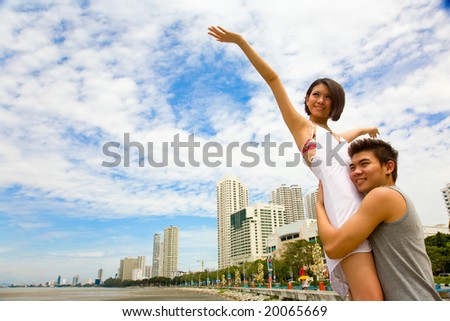 happy asian couples enjoying the vacation at the sea front