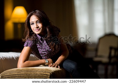 asian indian woman lying on the sofa