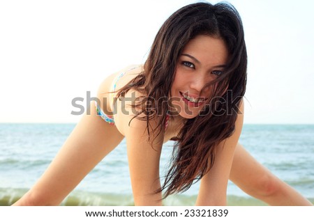 beautiful natural young woman having fun on the beach smiling