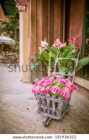 Vintage photo of flowers in an old cart
