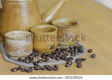 Soft focus image of coffee beans and coffee cups set on wooden background.Vintage style.(soft focus)