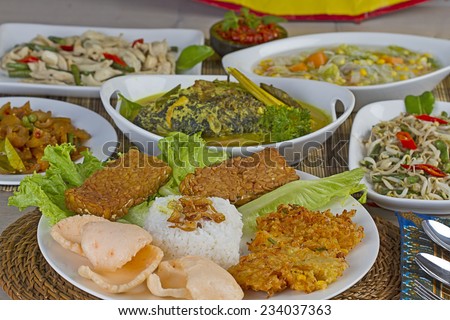 Indonesian lunch set menu, rice, vegetables, fish,chili paste, tempeh,chips, and corn fritter