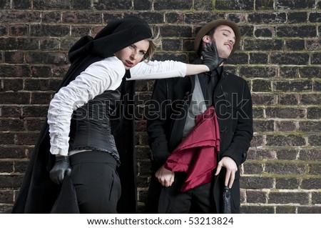 Couple in victorian costumes, woman strangling man.