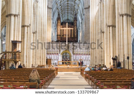 YORK, UK - MARCH 29: Aisle with rows of pews in York Minster central tower. The cathedral dates back from 1291. March 29, 2013 in York.