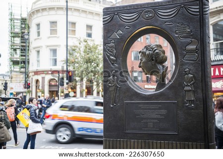 LONDON, UK - OCTOBER 26: Agatha Christie book shaped memorial with busy street in the background. The bronze memorial was unveiled on the 18 November 2012. October 26, 2014 in London.