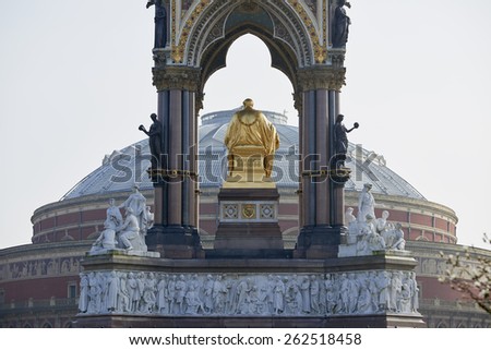 Albert Memorial statue overlooking hazy Royal Albert Hall, in London. The memorial was commissioned by Queen Victoria in memory of her husband, who died in 1861.