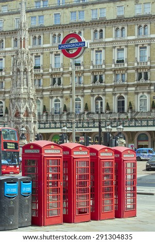 LONDON, UK - JUNE 15: Four traditional red phone booth with underground sign in front of Charing Cross station. June 15, 2015 in London.