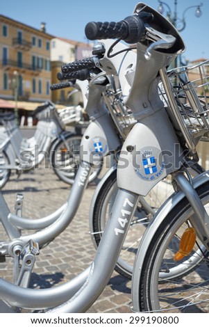VERONA, ITALY - JULY 11: Low angle cropped shot the city\'s cycle hire bicycles parked in line. July 11, 2015 in Verona.