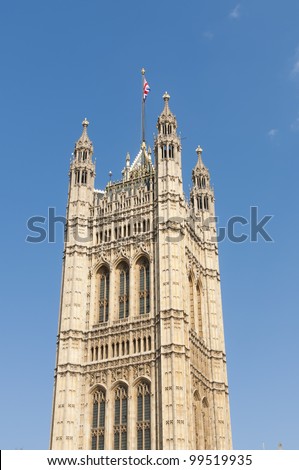 One of the towers of Houses of Parliament in London, UK, with British Union flag atop.