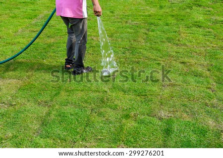 Workers watering lawn.