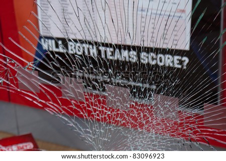 BIRMINGHAM - AUGUST 11 : A smashed window of a betting shop after it was smashed by looters on August 11, 2011 in Birmingham, UK.