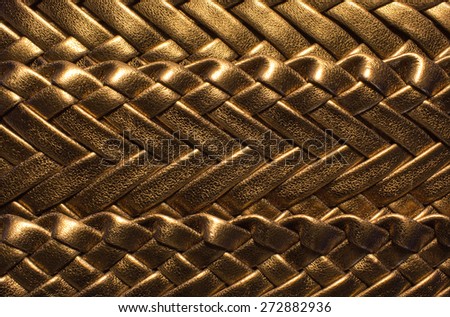 golden luxurious background with textured leather braided
