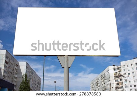 Blank billboard against a blue sky background in the city